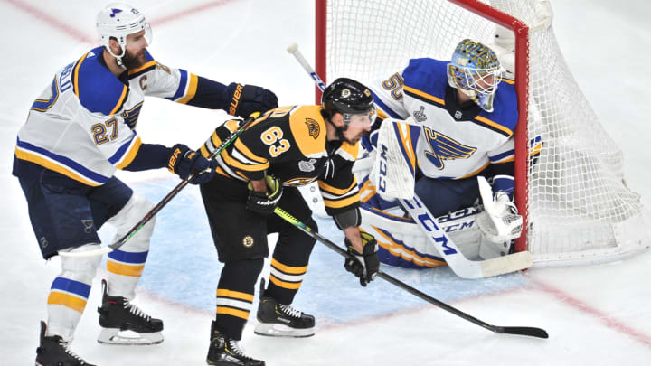 BOSTON, MA - JUNE 12: Boston Bruins left wing Brad Marchand (63) gets a hit from behind St. Louis Blues defenseman Alex Pietrangelo (27) in front of the net. During Game 7 of the Stanley Cup Finals featuring the Boston Bruins against the St. Louis Blues on June 12, 2019 at TD Garden in Boston, MA. (Photo by Michael Tureski/Icon Sportswire via Getty Images)