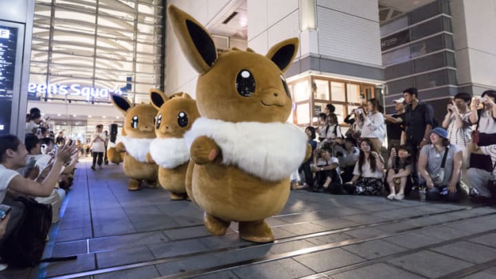YOKOHAMA, JAPAN - AUGUST 08: Performers dressed as Eevee, a character from the Pokémon media franchise managed by The Pokémon Company, march during the Pikachu Outbreak event at night on August 8, 2019 in Yokohama, Japan. A total of 2,000 Pikachus appear at the city's landmarks in the Minato Mirai area aiming to attract visitors and tourists to the city. The event will be held through August 12. (Photo by Tomohiro Ohsumi/Getty Images)
