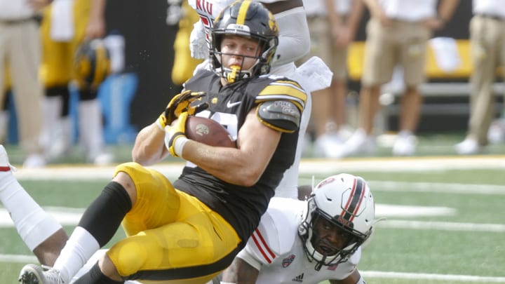 IOWA CITY, IOWA- SEPTEMBER 01: Tight end T.J. Hockenson #38 of the Iowa Hawkeyes is tripped up during the first half by safety Mykelti Williams #8 of the Northern Illinois Huskies on September 1, 2018 at Kinnick Stadium, in Iowa City, Iowa. (Photo by Matthew Holst/Getty Images)