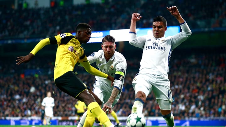 MADRID, SPAIN – DECEMBER 07: Ousmane Dembele of Borussia Dortmund is tackled by Sergio Ramos of Real Madrid and Casemiro of Real Madrid during the UEFA Champions League Group F match between Real Madrid CF and Borussia Dortmund at the Bernabeu on December 7, 2016, in Madrid, Spain. (Photo by Gonzalo Arroyo Moreno/Getty Images)