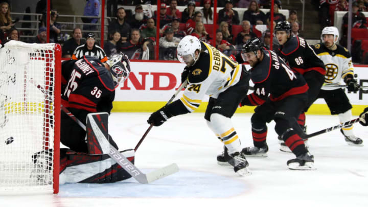 RALEIGH, NORTH CAROLINA - MAY 14: Curtis McElhinney #35 of the Carolina Hurricanes gives up a goal to Brad Marchand #63 of the Boston Bruins during the second period in Game Three of the Eastern Conference Finals during the 2019 NHL Stanley Cup Playoffs at PNC Arena on May 14, 2019 in Raleigh, North Carolina. (Photo by Bruce Bennett/Getty Images)