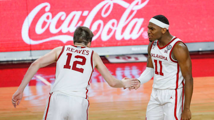 Jan 23, 2021; Norman, Oklahoma, USA; Oklahoma Sooners guard De'Vion Harmon (11) and guard Austin Reaves (12) celebrate after a score against the Kansas Jayhawks during the second half at Lloyd Noble Center. Oklahoma won 75-68. Mandatory Credit: Alonzo Adams-USA TODAY Sports