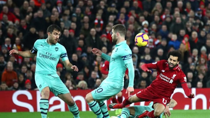 LIVERPOOL, ENGLAND - DECEMBER 29: Mohamed Salah of Liverpool is tackled in the build up to the first Liverpool goal during the Premier League match between Liverpool FC and Arsenal FC at Anfield on December 29, 2018 in Liverpool, United Kingdom. (Photo by Clive Brunskill/Getty Images)