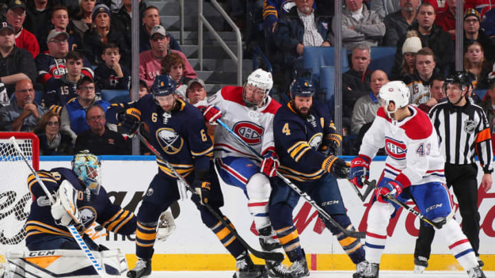 BUFFALO, NY - NOVEMBER 23: Marco Scandella #6, Carter Hutton #40 and Zach Bogosian #4 of the Buffalo Sabres defend against Nicolas Deslauriers #20 and Michael Chaput #43 of the Montreal Canadiens on November 23, 2018 at KeyBank Center in Buffalo, New York. (Photo by Bill Wippert/NHLI via Getty Images)