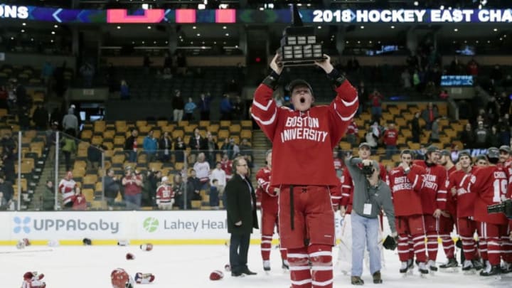 BOSTON, MA - MARCH 17: Boston University Terriers forward Brady Tkachuk (27) hoists the Lou Lamoniello Trophy after the Hockey East championship game between the Boston University Terriers and the Providence College Friars on March 18, 2018, at TD Garden in Boston, Massachusetts. The Terriers defeated the Friars 2-0. (Photo by Fred Kfoury III/Icon Sportswire via Getty Images)