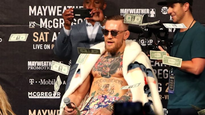 NEW YORK, NY - JULY 13: Conor McGregor looks on as money rains down during the Floyd Mayweather Jr. v Conor McGregor World Press Tour event at Barclays Center on July 13, 2017 in the Brooklyn borough of New York City. (Photo by Mike Lawrie/Getty Images)
