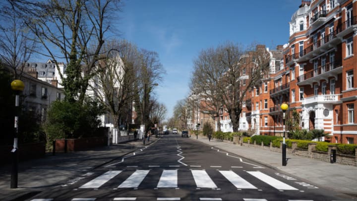 LONDON, ENGLAND - MARCH 24: The iconic Abbey Road crossing is seen after a re-paint by a Highways Maintenance team as they take advantage of the COVID-19 coronavirus lockdown and quiet streets to refresh the markings on March 24, 2020 in London, England. The Beatles made the pedestrian crossing famous after featuring a photograph of the group walking on it, near to Abbey Road Studios. The album and connected artwork celebrated its fiftieth anniversary last year. British Prime Minister, Boris Johnson, announced strict lockdown measures urging people to stay at home and only leave the house for basic food shopping, exercise once a day and essential travel to and from work. The Coronavirus (COVID-19) pandemic has spread to at least 182 countries, claiming over 10,000 lives and infecting hundreds of thousands more. (Photo by Leon Neal/Getty Images)