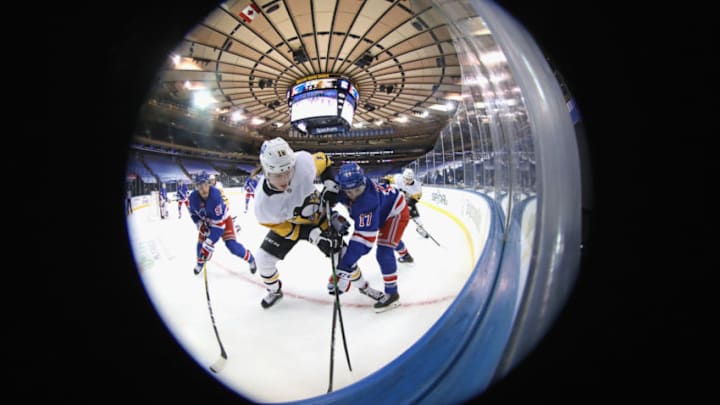 Jan 30, 2021; New York, New York, USA; Sam Lafferty #18 of the Pittsburgh Penguins and Kevin Rooney #17 of the New York Rangers battle for the puck during the third period at Madison Square Garden on January 30, 2021 in New York City. Mandatory Credit: Bruce Bennett/POOL PHOTOS-USA TODAY Sports