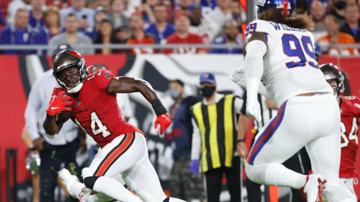 Nov 22, 2021; Tampa, Florida, USA; Tampa Bay Buccaneers wide receiver Chris Godwin (14) runs the ball in for a touchdown against the New York Giants during the first quarter at Raymond James Stadium. Mandatory Credit: Kim Klement-USA TODAY Sports