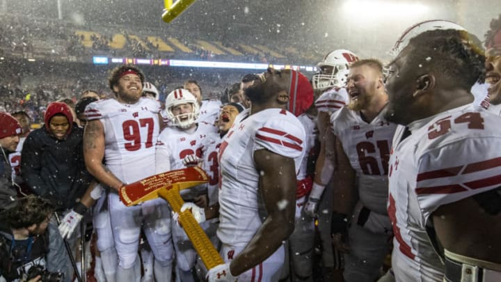 Nov 30, 2019; Minneapolis, MN, USA; Wisconsin Badgers linebacker Spencer Lytle (7) celebrates with the Paul Bunyan Axe Trophy after defeating the Minnesota Golden Gophers at TCF Bank Stadium. Mandatory Credit: Jesse Johnson-USA TODAY Sports