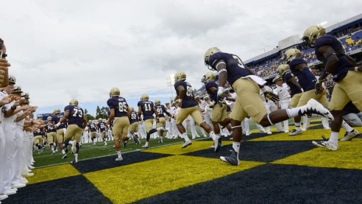 Sep 3, 2016; Annapolis, MD, USA; Navy Midshipmen run on the field before the game against the Fordham Rams at Navy Marine Corps Memorial Stadium. Mandatory Credit: Tommy Gilligan-USA TODAY Sports