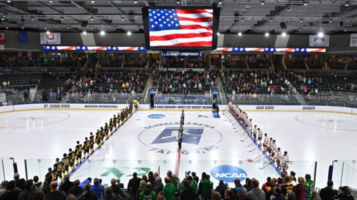 FARGO, NORTH DAKOTA - MARCH 30: The American International Yellow Jackets and the Denver Pioneers line up for the singing of the American national anthem before the NCAA Division I Men's Ice Hockey West Regional Championship Final at Scheels Arena on March 30, 2019 in Fargo, North Dakota. (Photo by Sam Wasson/Getty Images)