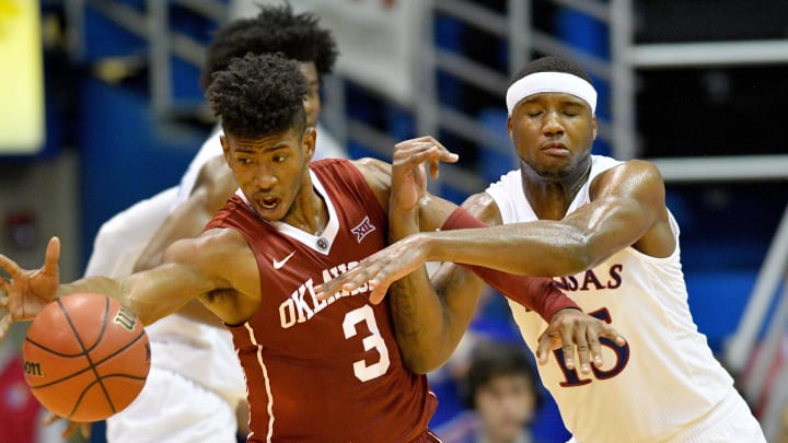 Feb 27, 2017; Lawrence, KS, USA; Oklahoma Sooners guard Christian James (3) and Kansas Jayhawks forward Carlton Bragg Jr. (15) battle for a rebound during the first half at Allen Fieldhouse. Mandatory Credit: Denny Medley-USA TODAY Sports