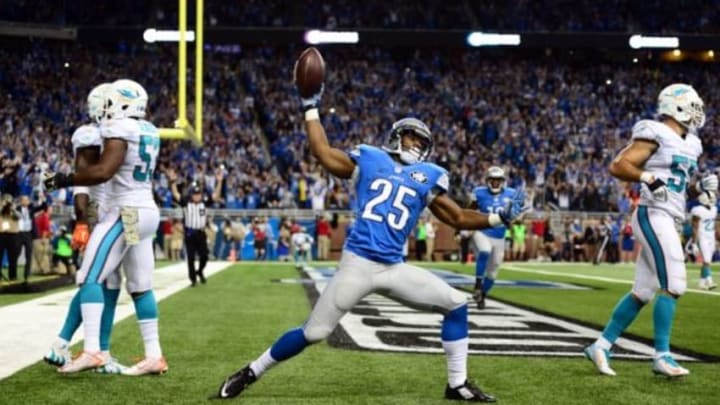 Nov 9, 2014; Detroit, MI, USA; Detroit Lions running back Theo Riddick (25) celebrates after catching a pass in the end zone for a touchdown during the fourth quarter against the Miami Dolphins at Ford Field. Mandatory Credit: Andrew Weber-USA TODAY Sports