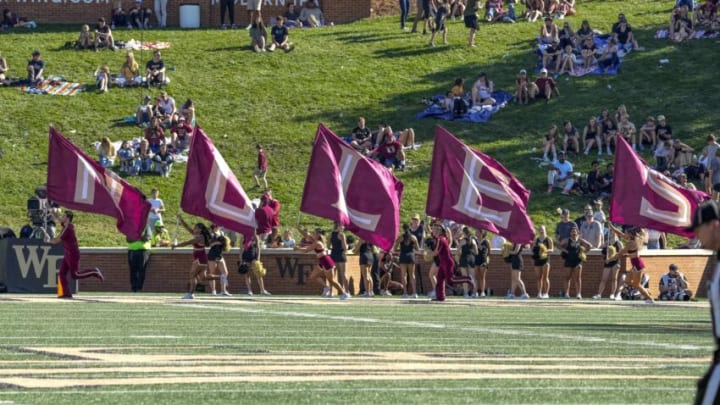 Oct 28, 2023; Winston-Salem, North Carolina, USA; Florida State Seminoles cheerleaders run with their mascot flags after a score against the Wake Forest Demon Deacons during the second half at Allegacy Federal Credit Union Stadium. Mandatory Credit: Jim Dedmon-USA TODAY Sports