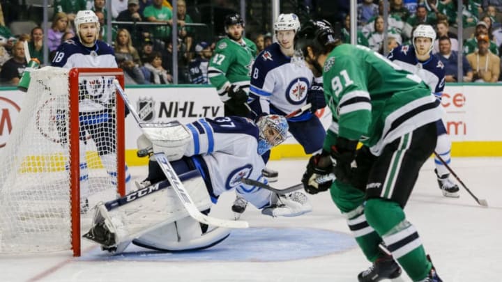 DALLAS, TX - OCTOBER 06: Dallas Stars center Tyler Seguin (91) scores a goal over Winnipeg Jets goaltender Connor Hellebuyck (37) during the game between the Dallas Stars and the Winnipeg Jets on October 6, 2018 at the American Airlines Center in Dallas, Texas. Dallas defeats Winnipeg 5-1. (Photo by Matthew Pearce/Icon Sportswire via Getty Images)
