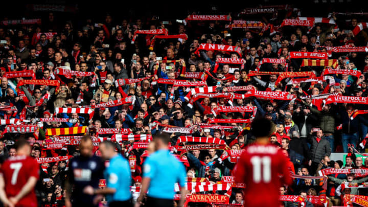 LIVERPOOL, ENGLAND - MARCH 07: Fans of Liverpool hold up scarves during the Premier League match between Liverpool FC and AFC Bournemouth at Anfield on March 7, 2020 in Liverpool, United Kingdom. (Photo by Robbie Jay Barratt - AMA/Getty Images)