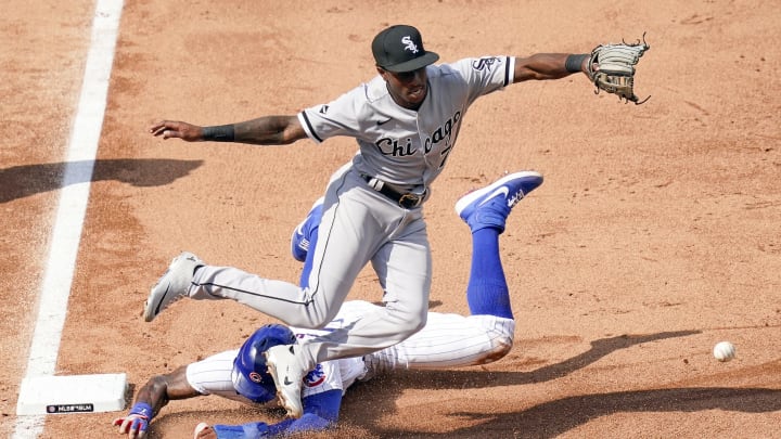 CHICAGO, ILLINOIS – AUGUST 23: Jason Heyward #22 of the Chicago Cubs is safe at third base past Tim Anderson #7 of the Chicago White Sox following a throwing error during the fifth inning of a game at Wrigley Field on August 23, 2020 in Chicago, Illinois. (Photo by Nuccio DiNuzzo/Getty Images)