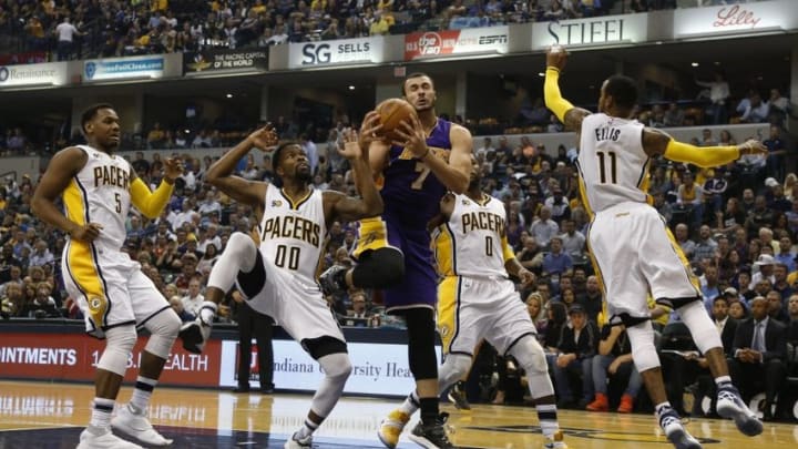 Nov 1, 2016; Indianapolis, IN, USA; Los Angeles Lakers forward Larry Nance Jr. (7) grabs a rebound against Indiana Pacers guard Aaron Brooks (00) in the first quarter at Bankers Life Fieldhouse. Mandatory Credit: Brian Spurlock-USA TODAY Sports