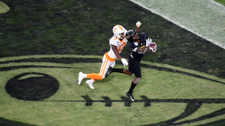 Dec 30, 2021; Nashville, TN, USA; Purdue Boilermakers wide receiver TJ Sheffield (8) catches a touchdown pass as he is defended by Tennessee Volunteers defensive back Kamal Hadden (13) during the second half in the 2021 Music City Bowl at Nissan Stadium. Mandatory Credit: Christopher Hanewinckel-USA TODAY Sports