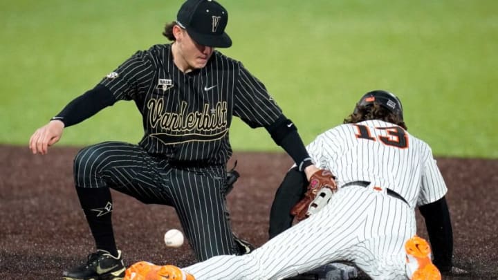 Oklahoma State right fielder Nolan McLean (13) steals second under Vanderbilt shortstop Carter Young (9) during the fourth inning at Hawkins Field in Nashville, Tenn., Friday, Feb. 18, 2022.Vandy Os Bb 021822 An 016