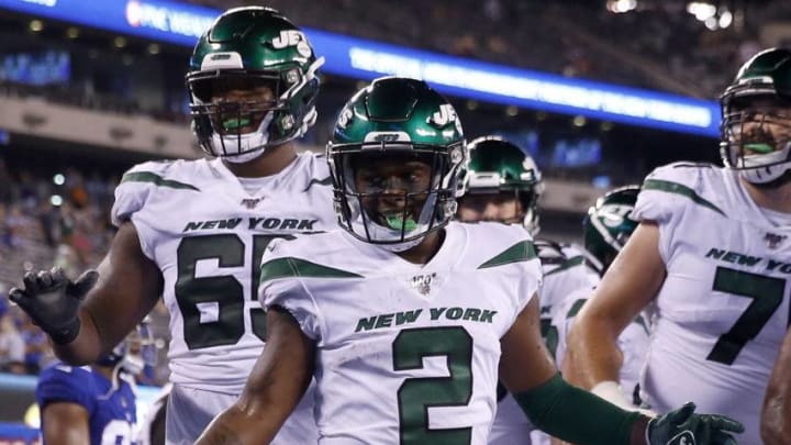 EAST RUTHERFORD, NEW JERSEY - AUGUST 08: Greg Dortch #2 of the New York Jets celebrates his touchdown with teammates Charone Peake #17 and Ben Braden #69 in the fourth quarter against the New York Giants during a preseason matchup at MetLife Stadium on August 08, 2019 in East Rutherford, New Jersey. (Photo by Elsa/Getty Images)