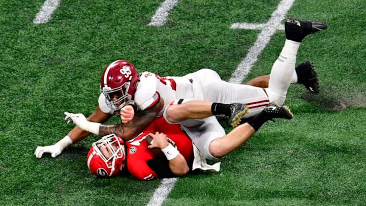ATLANTA, GA - JANUARY 08: Jake Fromm #11 of the Georgia Bulldogs is sacked by Raekwon Davis #99 of the Alabama Crimson Tide in the CFP National Championship presented by AT&T at Mercedes-Benz Stadium on January 8, 2018 in Atlanta, Georgia. (Photo by Scott Cunningham/Getty Images)