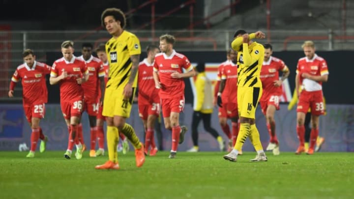 Dortmund's Swiss defender Manuel Akanji (R) reacts after a goal by Union Berlin during the German first division Bundesliga football match Union Berlin v Borussia Dortmund in Berlin on December 18, 2020. - Union Berlin defeated Dortmund 2-1. (Photo by ANNEGRET HILSE / POOL / AFP) / DFL REGULATIONS PROHIBIT ANY USE OF PHOTOGRAPHS AS IMAGE SEQUENCES AND/OR QUASI-VIDEO (Photo by ANNEGRET HILSE/POOL/AFP via Getty Images)