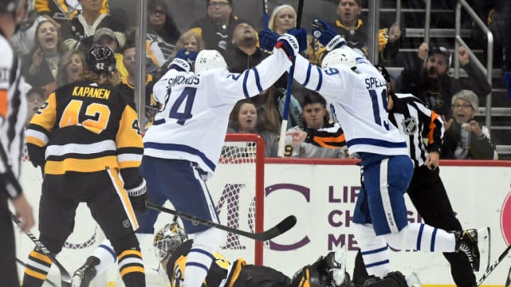 Oct 23, 2021; Pittsburgh, Pennsylvania, USA; Toronto Maple Leafs right wing Wayne Simmonds (24) and Jason Spezza (19) celebrate after a first period goal as Pittsburgh Penguins goaltender Tristan Jarry (35) looks at the puck at PPG Paints Arena. Mandatory Credit: Philip G. Pavely-USA TODAY Sports