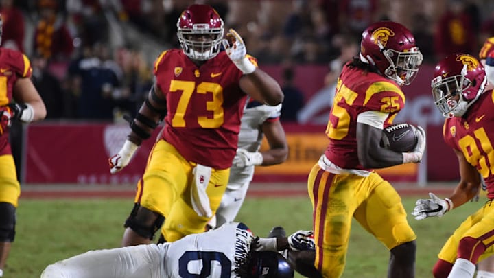 LOS ANGELES, CA - NOVEMBER 04: Running back Ronald Jones II #25 of the USC Trojans breaks a tackle by safety Demetrius Flannigan-Fowles #6 of the Arizona Wildcats and runs for a first down in the second half of the game at the Los Angeles Memorial Coliseum on November 4, 2017 in Los Angeles, California. (Photo by Jayne Kamin-Oncea/Getty Images) LOS ANGELES, CA - NOVEMBER 04: Running back Ronald Jones II #25 of the USC Trojans breaks a tackle by safety Demetrius Flannigan-Fowles #6 of the Arizona Wildcats and runs for a first down in the second half of the game at the Los Angeles Memorial Coliseum on November 4, 2017 in Los Angeles, California. (Photo by Jayne Kamin-Oncea/Getty Images)
