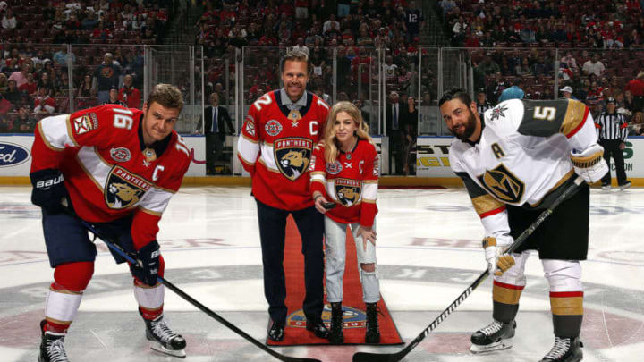SUNRISE, FL - FEBRUARY 2: Former member of the Florida Panthers Olli Jokinen drops the ceremonial puck with his daughter Emma along with Aleksander Barkov #16 of the Florida Panthers and Deryk Engelland #5 of the Vegas Golden Knights prior to the start of the game at the BB&T Center on February 2, 2019 in Sunrise, Florida. (Photo by Eliot J. Schechter/NHLI via Getty Images)