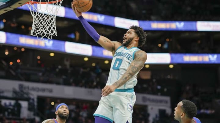 Mar 28, 2022; Charlotte, North Carolina, USA; Charlotte Hornets forward Miles Bridges (0) goes up for a layup against the Denver Nuggets during the second half at Spectrum Center. Mandatory Credit: Jim Dedmon-USA TODAY Sports