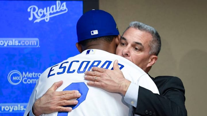 Kansas City Royals' Alcides Escobar hugs general manager Dayton Moore after a re-signing press conference on Monday, January 29, 2018 at Kauffman Stadium in Kansas City, Mo. (John Sleezer/Kansas City Star/TNS via Getty Images)