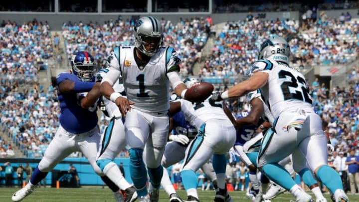 CHARLOTTE, NC - OCTOBER 07: Cam Newton #1 hands off to teammate Christian McCaffrey #22 of the Carolina Panthers against the New York Giants in the first quarter during their game at Bank of America Stadium on October 7, 2018 in Charlotte, North Carolina. (Photo by Streeter Lecka/Getty Images)