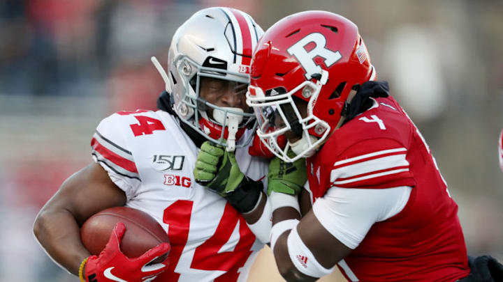 PISCATAWAY, NEW JERSEY - NOVEMBER 16: K.J. Hill #14 of the Ohio State Buckeyes carries the ball as Tim Barrow #4 of the Rutgers Scarlet Knights defends in the first quarter at SHI Stadium on November 16, 2019 in Piscataway, New Jersey. (Photo by Elsa/Getty Images)