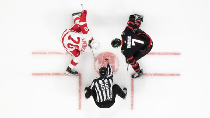 OTTAWA, ONTARIO - APRIL 03: Oskar Sundqvist #70 of the Detroit Red Wings takes a face-off against Brady Tkachuk #7 of the Ottawa Senators at Canadian Tire Centre on April 03, 2022 in Ottawa, Ontario. (Photo by Chris Tanouye/Getty Images)