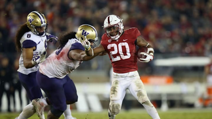 PALO ALTO, CA - NOVEMBER 10: Bryce Love #20 of the Stanford Cardinal breaks away from Vita Vea #50 of the Washington Huskies at Stanford Stadium on November 10, 2017 in Palo Alto, California. (Photo by Ezra Shaw/Getty Images)