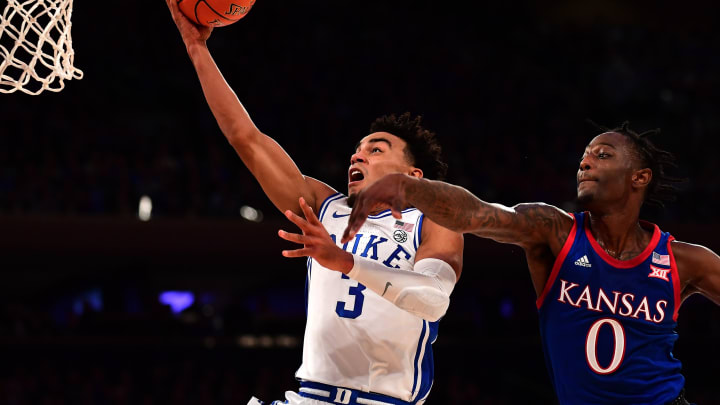 NEW YORK, NEW YORK – NOVEMBER 05: Tre Jones #3 of the Duke Blue Devils goes in for a layup while being guarded by Marcus Garrett #0 of the Kansas Jayhawks in the first half of their game at Madison Square Garden on November 05, 2019 in New York City. (Photo by Emilee Chinn/Getty Images)