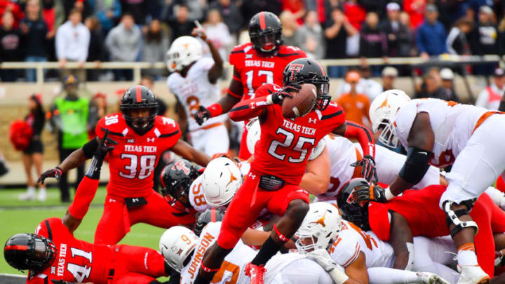 LUBBOCK, TX - NOVEMBER 05: Douglas Coleman #25 of the Texas Tech Red Raiders strips the ball and will score a touchdown during the first half of the game between the Texas Tech Red Raiders and the Texas Longhorns on November 5, 2016 at AT&T Jones Stadium in Lubbock, Texas. (Photo by John Weast/Getty Images)