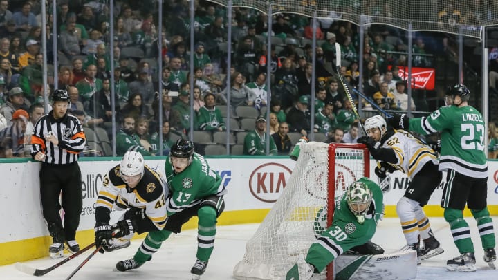 DALLAS, TX - NOVEMBER 16: Boston Bruins right wing David Backes (42) and Dallas Stars center Mattias Janmark (13) battle for the puck behind the net during the game between the Dallas Stars and the Boston Bruins on November 16, 2018 at the American Airlines Center in Dallas, Texas. (Photo by Matthew Pearce/Icon Sportswire via Getty Images)