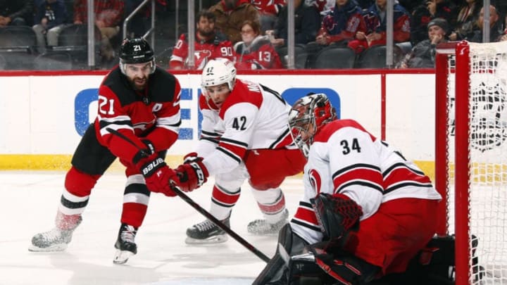 NEWARK, NJ - FEBRUARY 10: Petr Mrazek #34 of the Carolina Hurricanes makes a save as Kyle Palmieri #21 of the New Jersey Devils looks for the rebound during the game at Prudential Center on February 10, 2019 in Newark, New Jersey. (Photo by Adam Hunger/Getty Images)