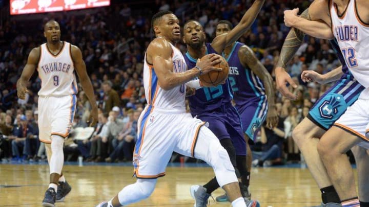 Jan 20, 2016; Oklahoma City, OK, USA; Oklahoma City Thunder guard Russell Westbrook (0) drives to the basket in front of Charlotte Hornets guard Kemba Walker (15) during the third quarter at Chesapeake Energy Arena. Mandatory Credit: Mark D. Smith-USA TODAY Sports