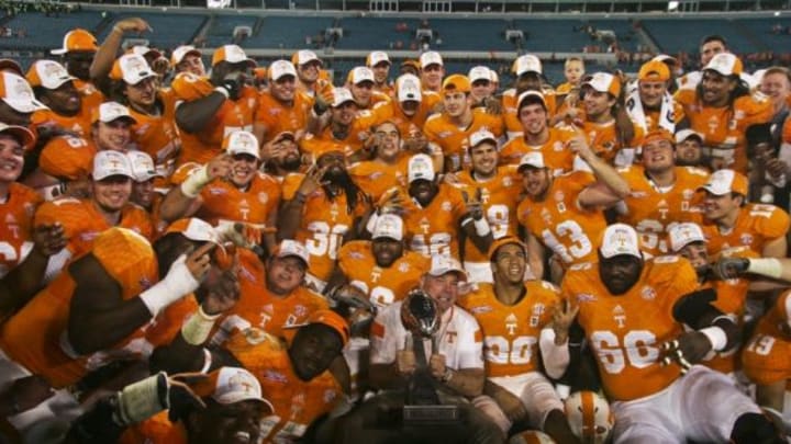 Jan 2, 2015; Jacksonville, FL, USA; The Tennessee Volunteers team takes a group photo with their trophy after their 2015 TaxSlayer Bowl game against the Iowa Hawkeyes at EverBank Field. The Tennessee Volunteers beat the Iowa Hawkeyes 45-28. Mandatory Credit: Phil Sears-USA TODAY Sports