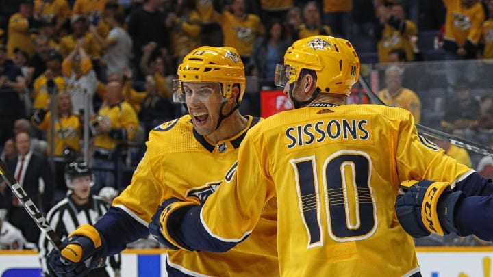NASHVILLE, TENNESSEE – OCTOBER 10: Nick Bonino #13 of the Nashville Predators is congratulated by teammate Colton Sissons #10 after scoring the game tying goal against the Washington Capitals during the third period of a 6-5 Predators victory over the Capitals at Bridgestone Arena on October 10, 2019 in Nashville, Tennessee. (Photo by Frederick Breedon/Getty Images)