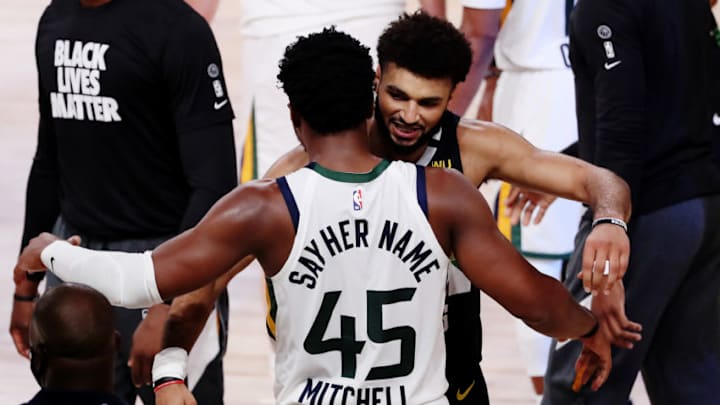 LAKE BUENA VISTA, FLORIDA - SEPTEMBER 01: Donovan Mitchell #45 of the Utah Jazz hugs Jamal Murray #27 of the Denver Nuggets after the game ends and the Denver Nuggets wiin Game Seven of the Western Conference First Round during the 2020 NBA Playoffs at AdventHealth Arena at ESPN Wide World Of Sports Complex on September 01, 2020 in Lake Buena Vista, Florida. NOTE TO USER: User expressly acknowledges and agrees that, by downloading and or using this photograph, User is consenting to the terms and conditions of the Getty Images License Agreement. (Photo by Mike Ehrmann/Getty Images)