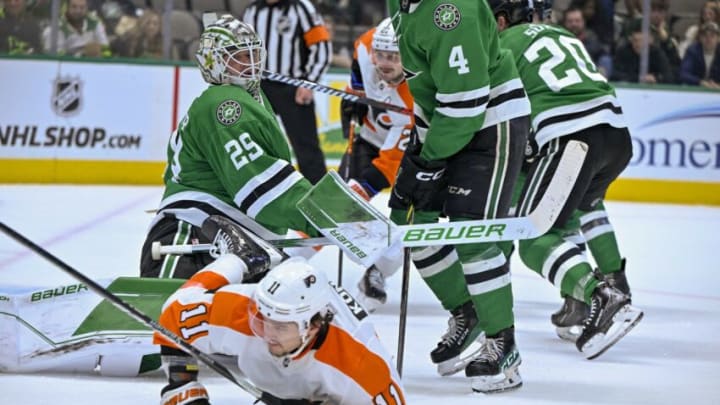 Apr 6, 2023; Dallas, Texas, USA; Philadelphia Flyers right wing Travis Konecny (11) is tripped up in front of Dallas Stars goaltender Jake Oettinger (29) during the third period at the American Airlines Center. Mandatory Credit: Jerome Miron-USA TODAY Sports
