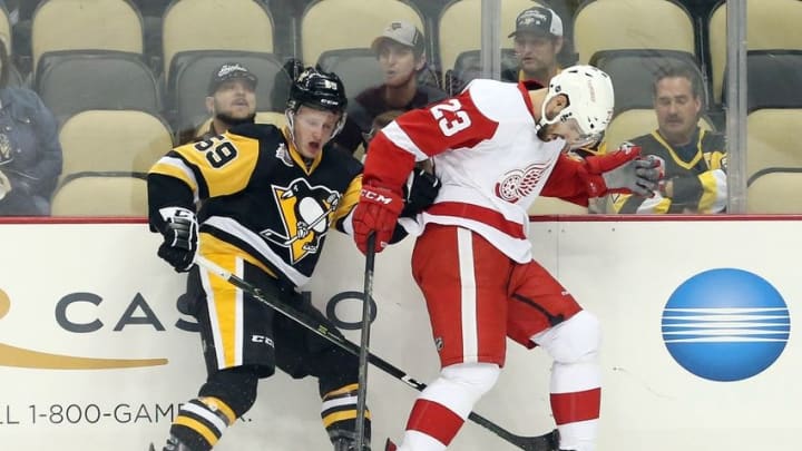 Oct 5, 2016; Pittsburgh, PA, USA; Pittsburgh Penguins center Jake Guentzel (59) and Detroit Red Wings defenseman Btian Lashoff (23) battle for the puck during the first period at the PPG Paints Arena. Mandatory Credit: Charles LeClaire-USA TODAY Sports