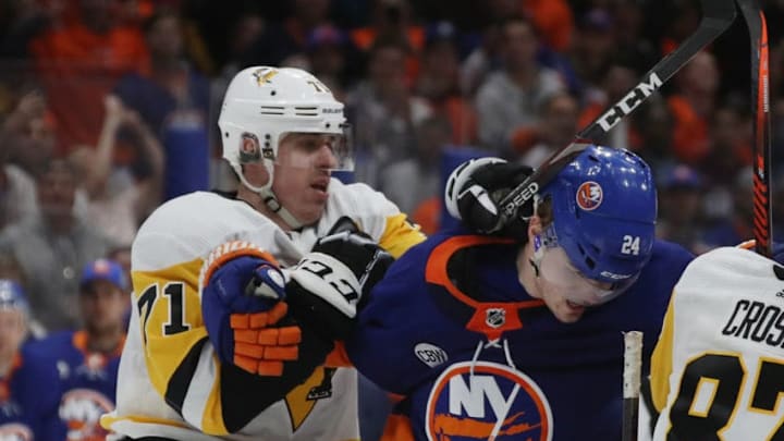 UNIONDALE, NEW YORK - APRIL 12: Evgeni Malkin #71 of the Pittsburgh Penguins hits Scott Mayfield #24 of the New York Islanders at the end of their game in Game Two of the Eastern Conference First Round during the 2019 NHL Stanley Cup Playoffs at NYCB Live's Nassau Coliseum on April 12, 2019 in Uniondale, New York. The Islanders defeated the Penguins 3-1. (Photo by Bruce Bennett/Getty Images)