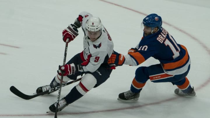 UNIONDALE, NY - OCTOBER 04: Washington Capitals Defenseman Dmitry Orlov (9) and New York Islanders Center Derick Brassard (10) battle for the puck during the second period of the game between the Washington Capitals and the New York Islanders on October 4, 2019, at Nassau Veterans Memorial Coliseum in Uniondale, NY> (Photo by Gregory Fisher/Icon Sportswire via Getty Images)