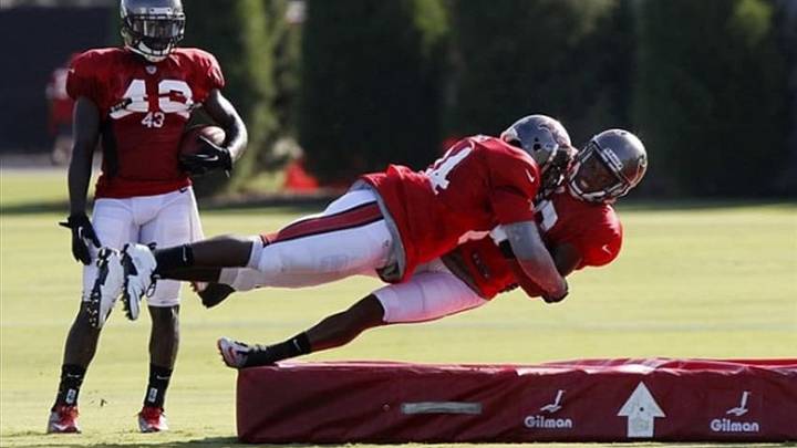 Aug 3, 2013; Tampa, FL, USA; Tampa Bay Buccaneers cornerback Darrelle Revis (24) tackles during a drill at training camp at One Buc Place. Mandatory Credit: Kim Klement-USA TODAY Sports
